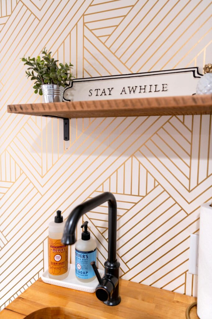 Bright and stylish kitchen corner with geometric wallpaper and decor.
