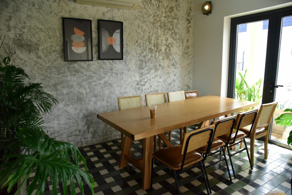 Minimalist dining room featuring a wooden table and chairs, perfect for a stylish home setup.